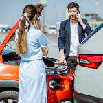 two people looking at a car accident